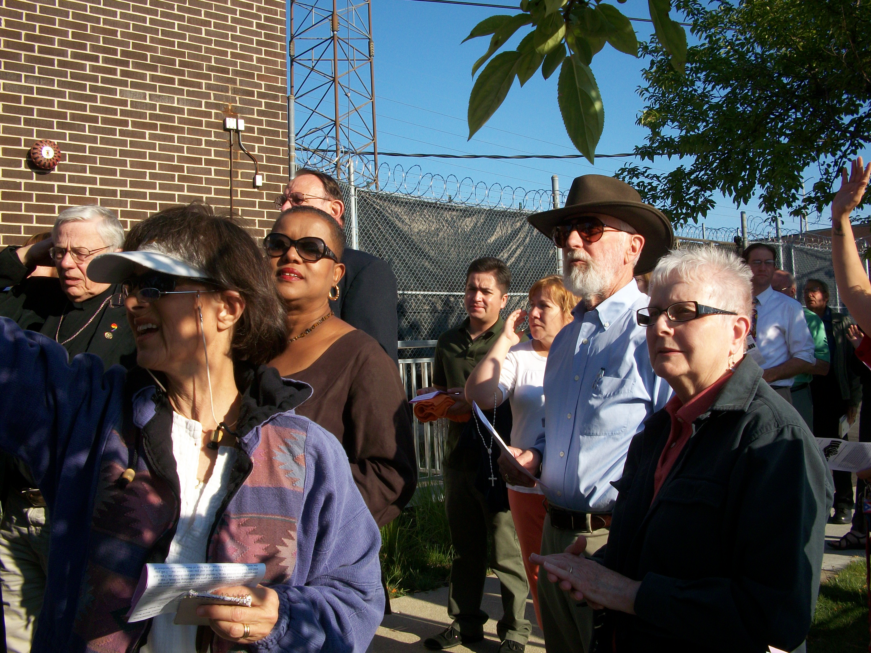 A crowd prays at a detention center in Illinois, June 2012, blessing a bus as it brings immigrants to the airport to be deported. Photo by Julia Walsh FSPA
