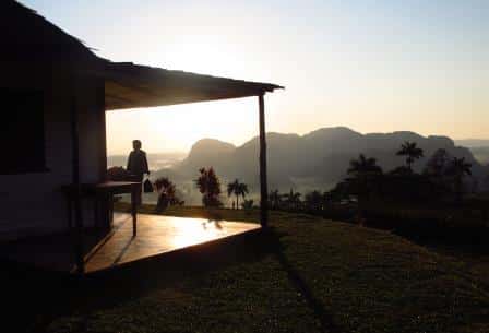 deck-woman-mountains-sunset