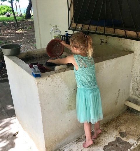 small-girl-washing-dishes-teal-dress