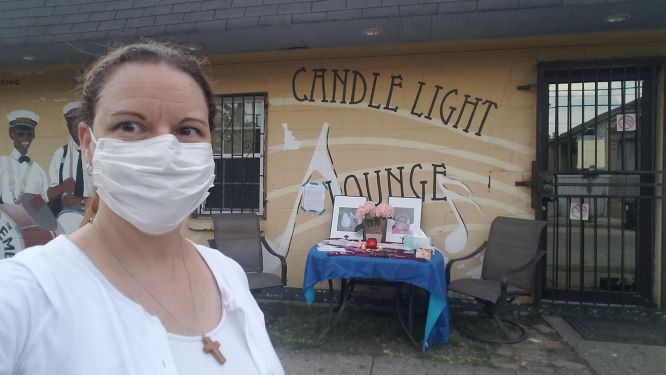 woman-white-surgical-mask-building-candle-light-lounge