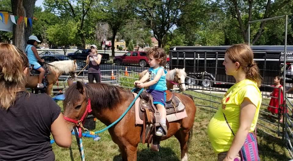 BVM Assumption Parish parishioners ride ponies at picnic