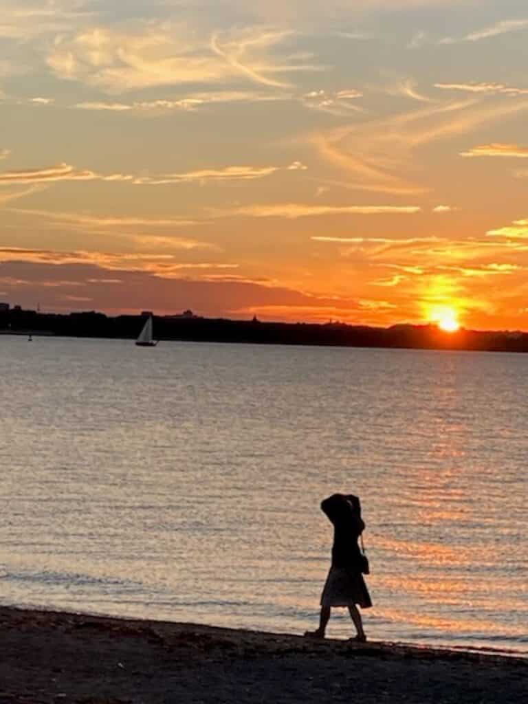 person-walking-beach-sunset