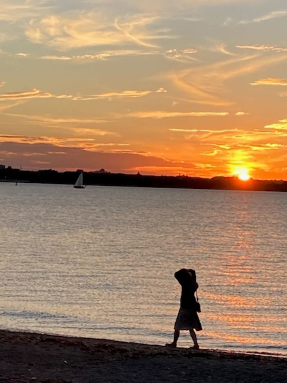 person-walking-beach-sunset