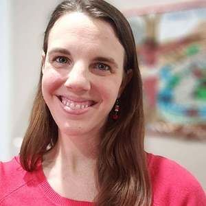Emily Cortina, woman with long brown hair and pink shirt