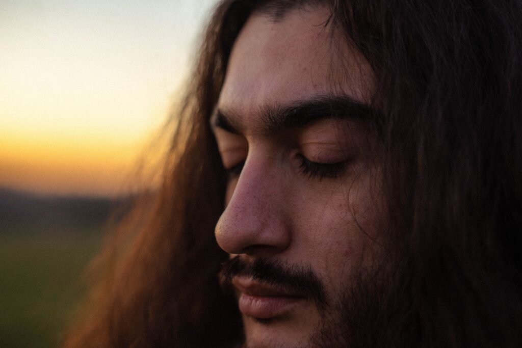 closeup-image-man-long hair-mustache-sunset