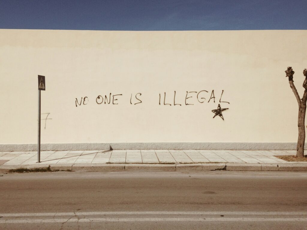 No one is illegal written on a wall