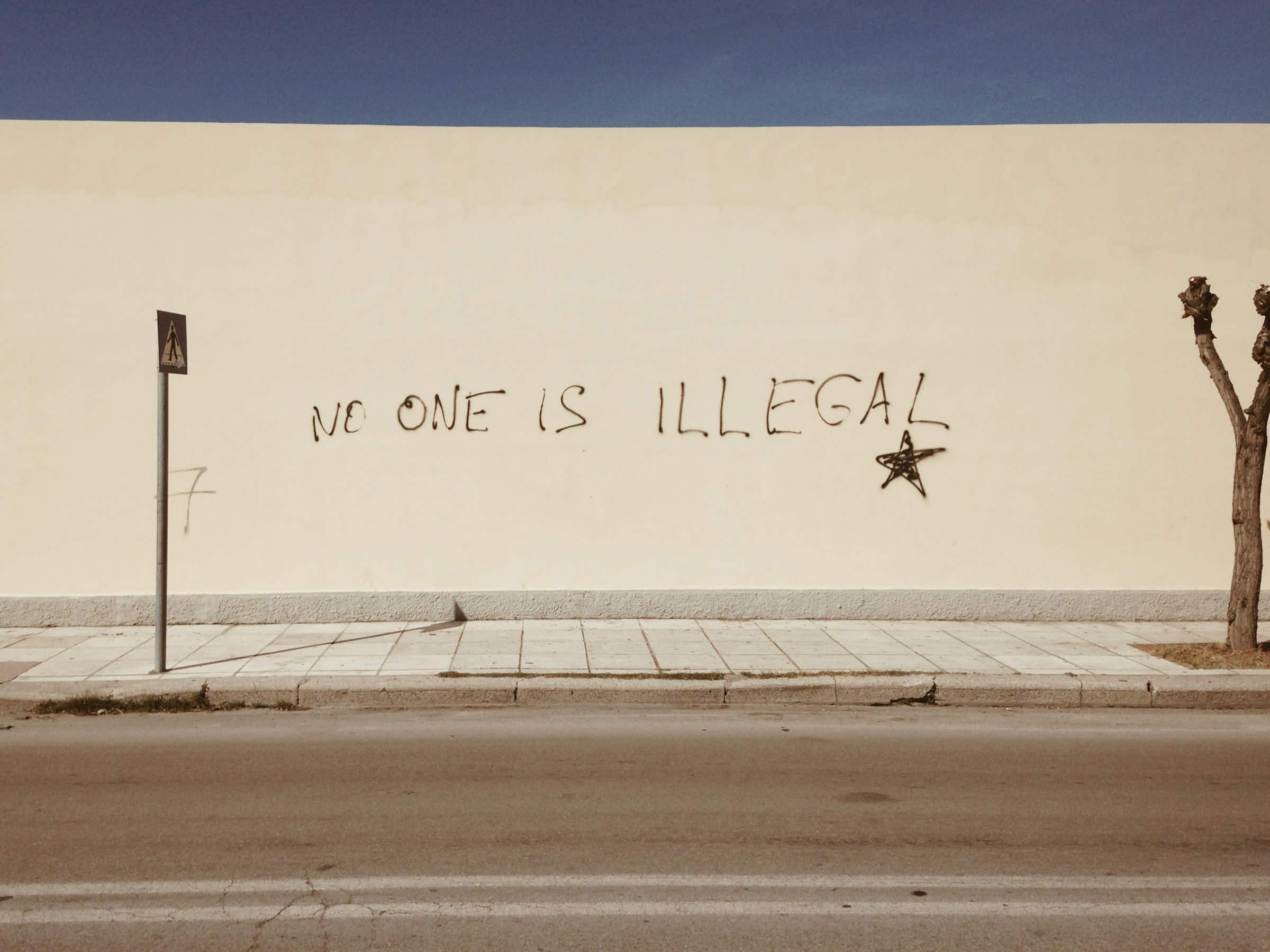 No one is illegal written on a wall