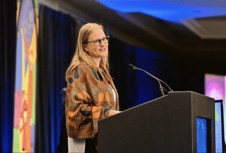 Dr. Ann Garrick speaking onstage