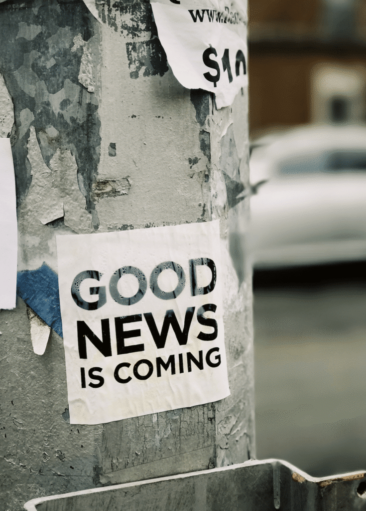 A sign on a post that says Good News is Coming