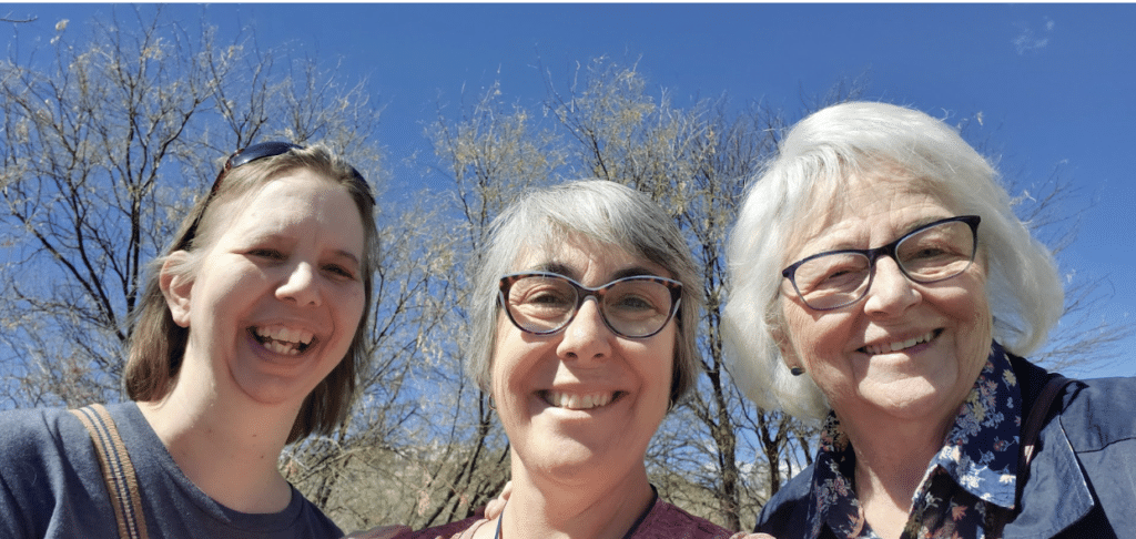 A photo of Sr. Sarah Hennessy, Sr. Eileen McKenzie, and Sr. Linda Mershon against a blue sky with trees in the background