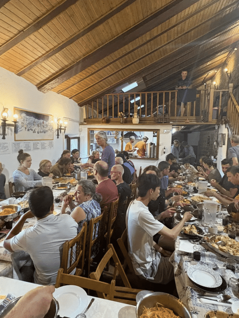 Two long tables crowded with people feasting.