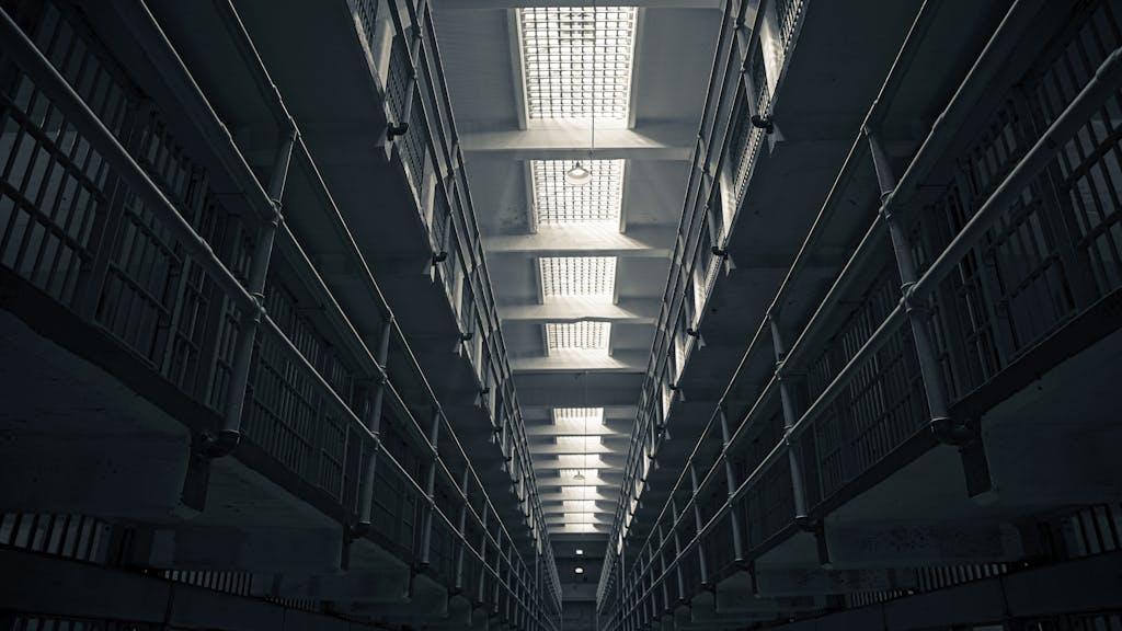 A low-angle view of Alcatraz prison cell block, showcasing steel railings.