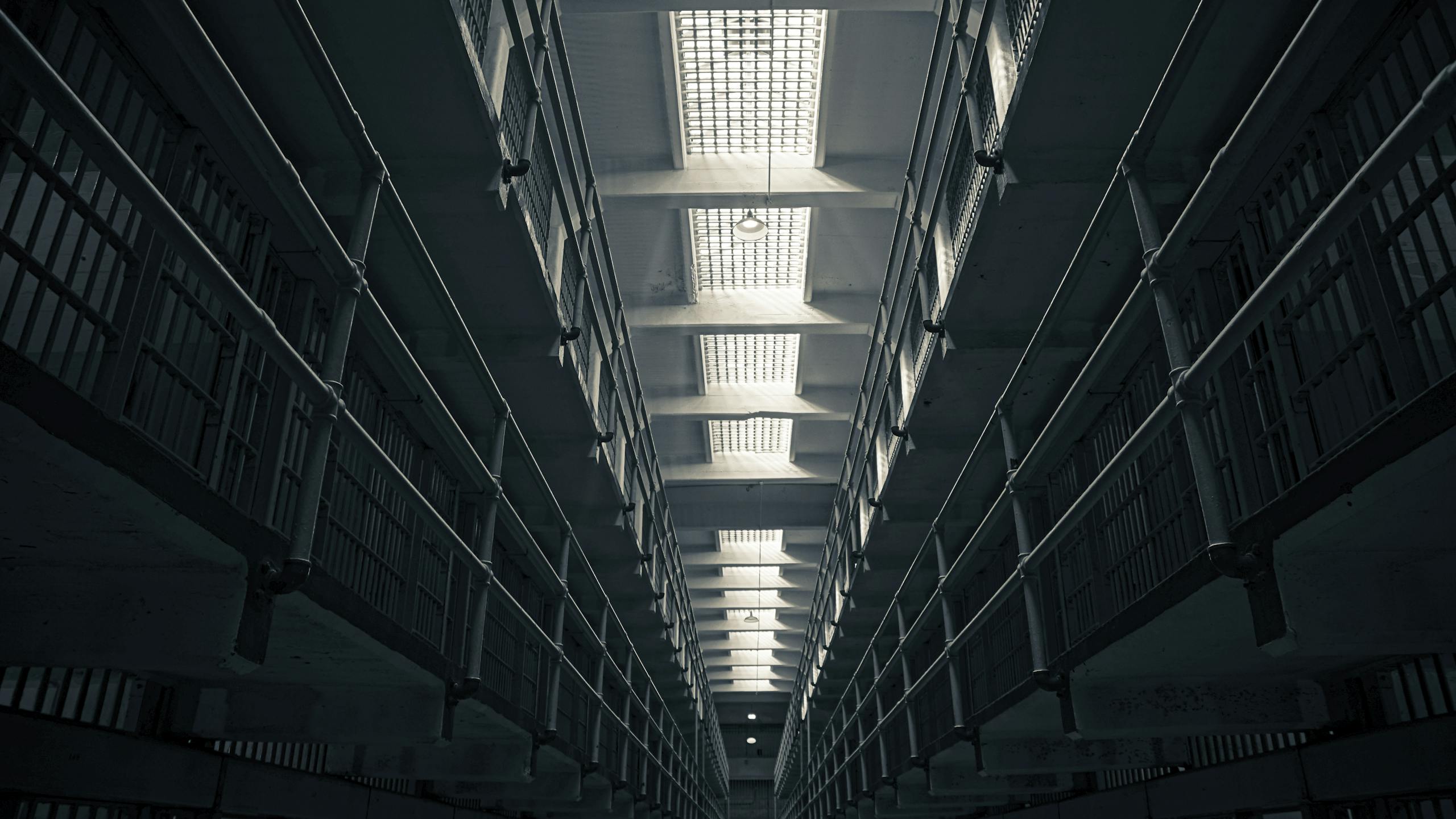A low-angle view of Alcatraz prison cell block, showcasing steel railings.
