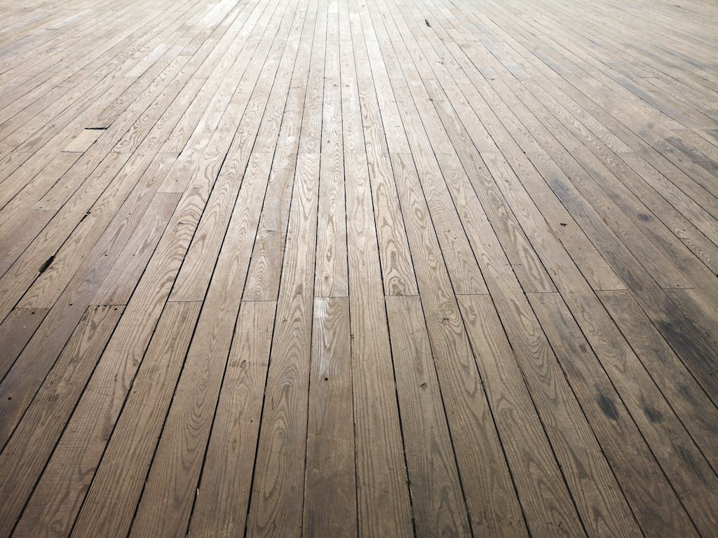 A wide angle view of aged wooden floor planks showing natural texture and grain pattern.