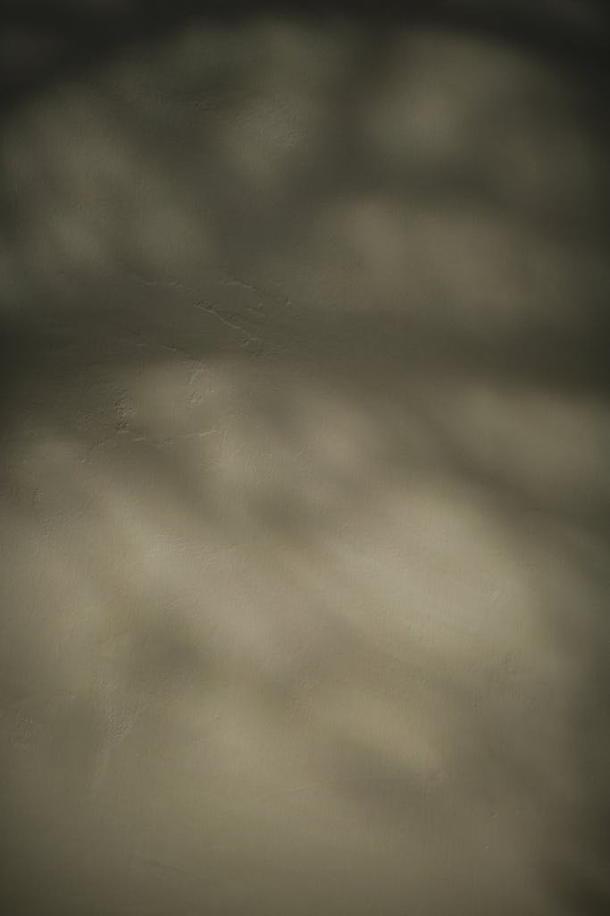 Blurred abstract texture with defocused shadows and gentle hues, ideal for creative backdrops.