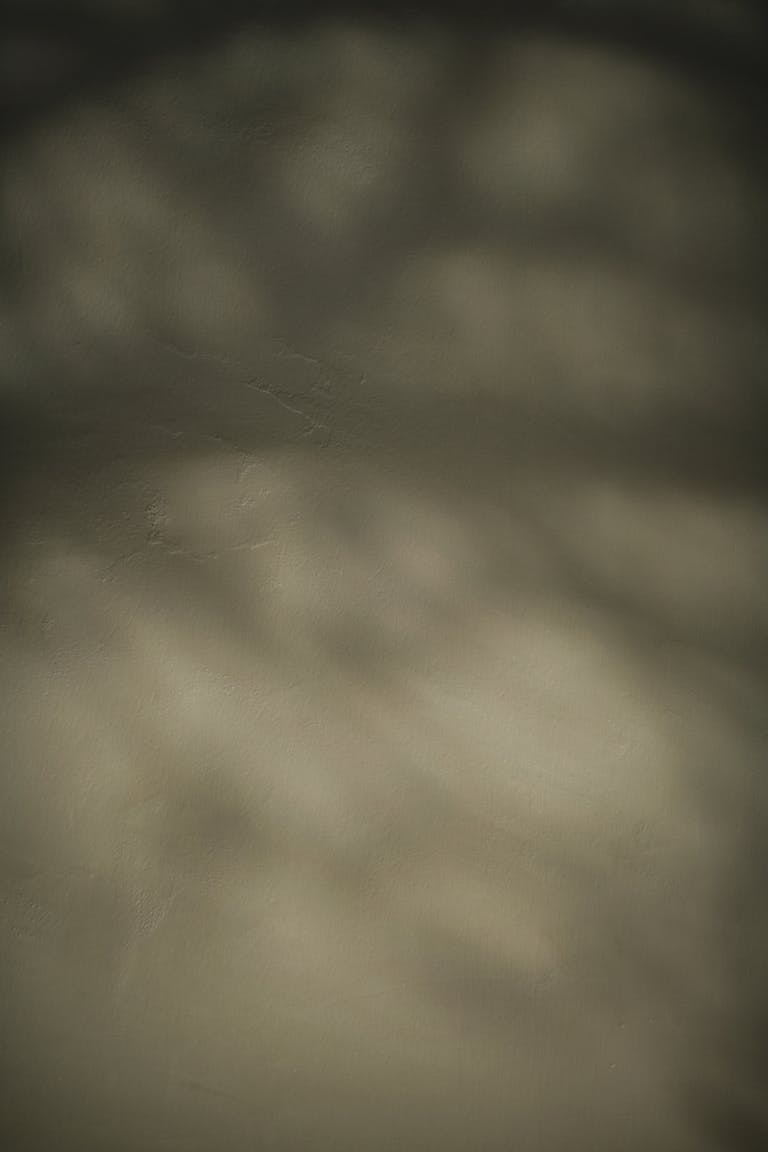 Blurred abstract texture with defocused shadows and gentle hues, ideal for creative backdrops.