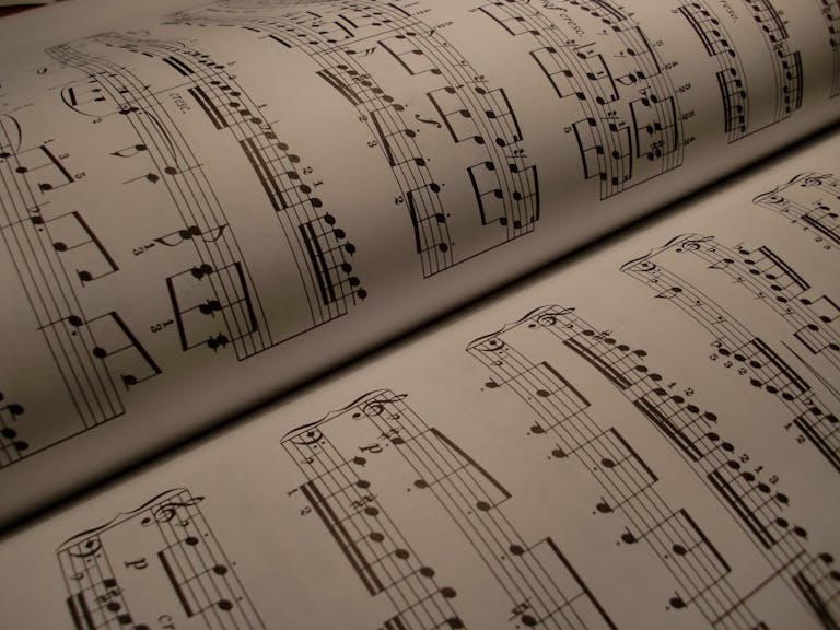 Detailed view of an open music book displaying musical notes and sheet music.
